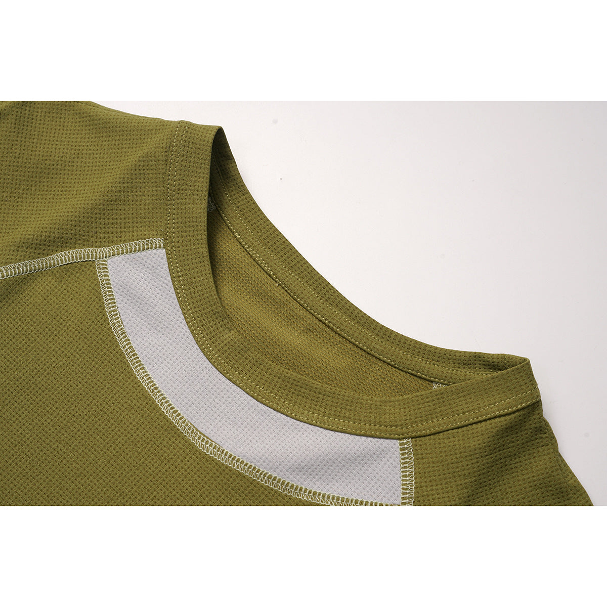 Close-up of an olive long-sleeve top's crew neckline and white mesh inset with visible stitching.