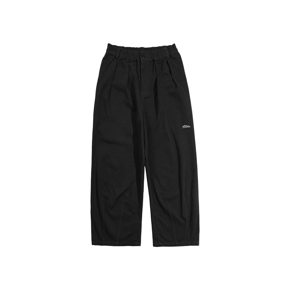 Black wide-leg pants with elastic waistband, front pleats and small embroidered logo, flat lay on white