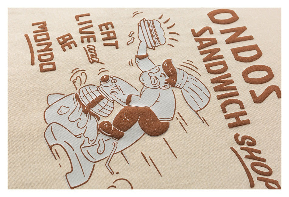 Close-up of a raised brown sandwich-shop phrase and cartoon illustration printed on cream fabric.