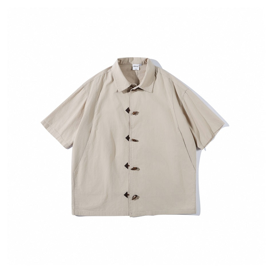 Khaki short-sleeve collared shirt with front horn-style toggle closures, flat lay front view
