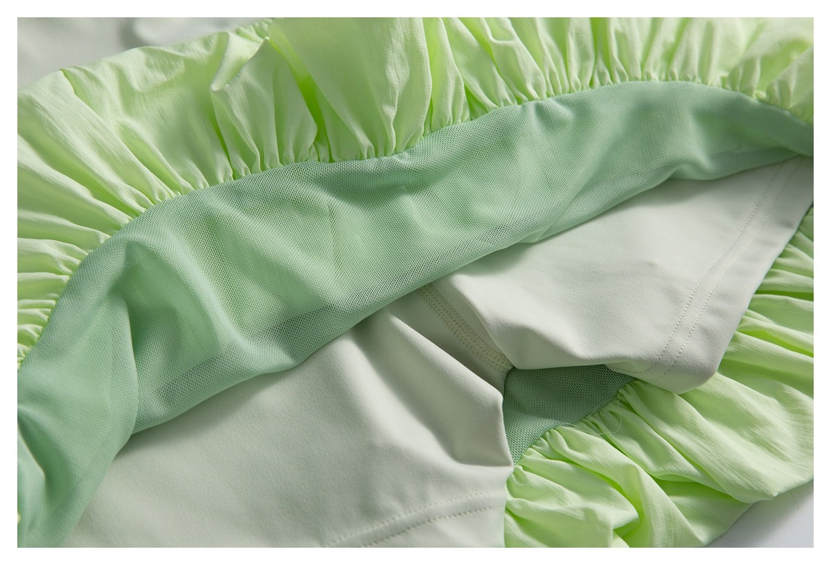 Inside view of the pale green skirt showing its lining, mesh panel, and gathered construction.