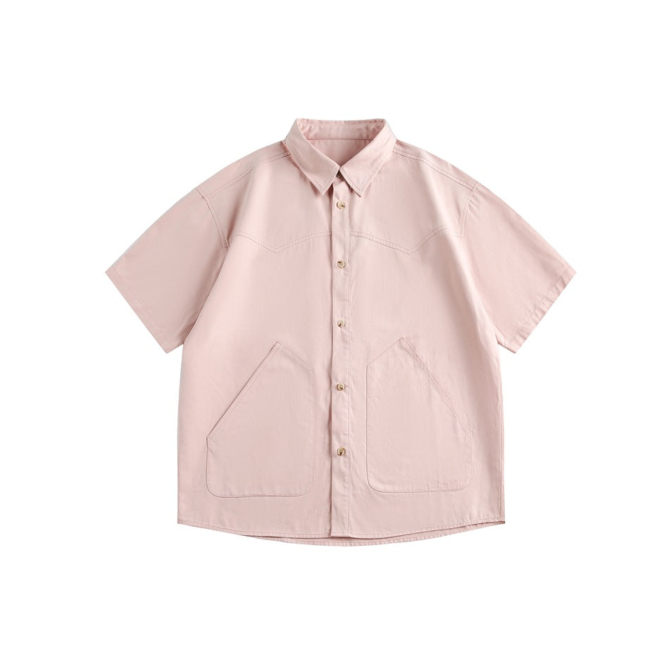 Pink short-sleeve button-front shirt with pointed collar and two large angular front pockets, flat lay
