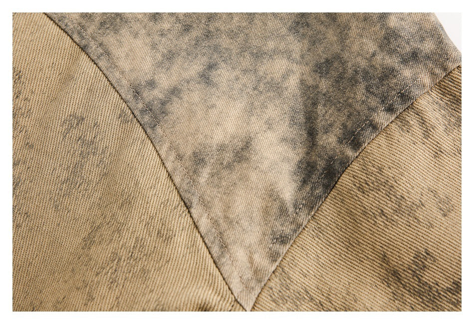 Close-up of a triangular mottled fabric panel joined to tan ribbed sections by visible seams.