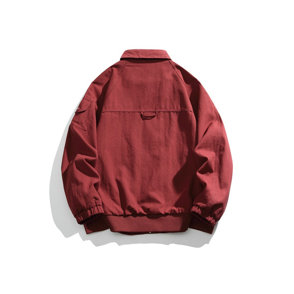 Back view of a red jacket with a pointed collar, sleeve pocket, elastic cuffs and ribbed hem.