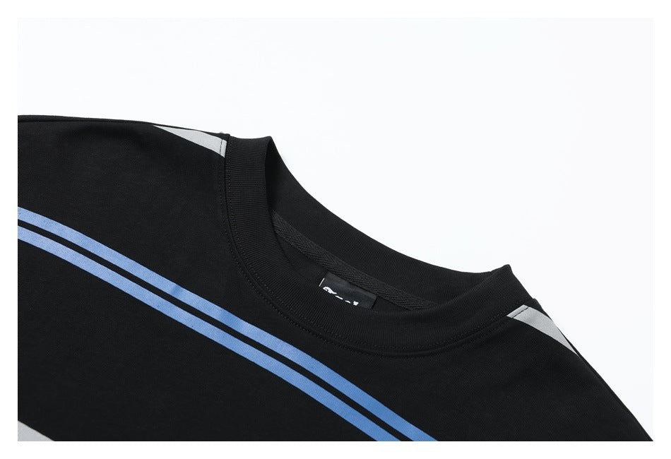 Close-up of a black crew-neck shirt with blue and white stripes across the shoulder and chest.