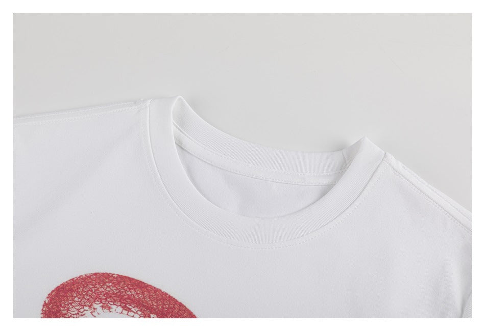 Close-up of the white T-shirt's crew neckline and upper chest, with part of the red print visible.