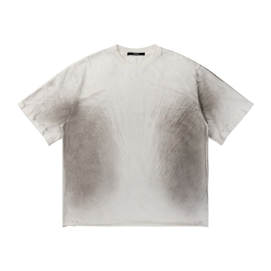 Off-white short-sleeve crew neck T-shirt with gray spray smudges and small distressed slits, front view