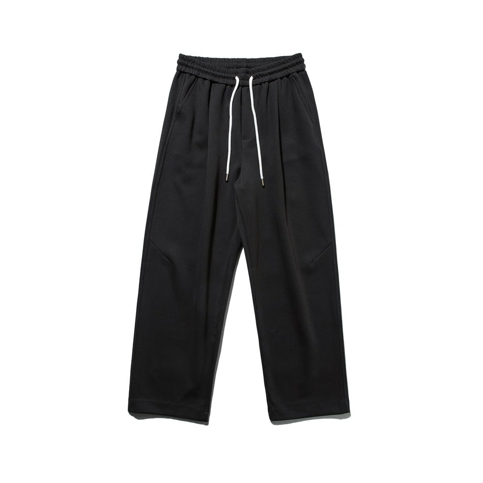 Dark gray straight-leg sweatpants with white drawstring and diagonal knee seams, flat lay front view