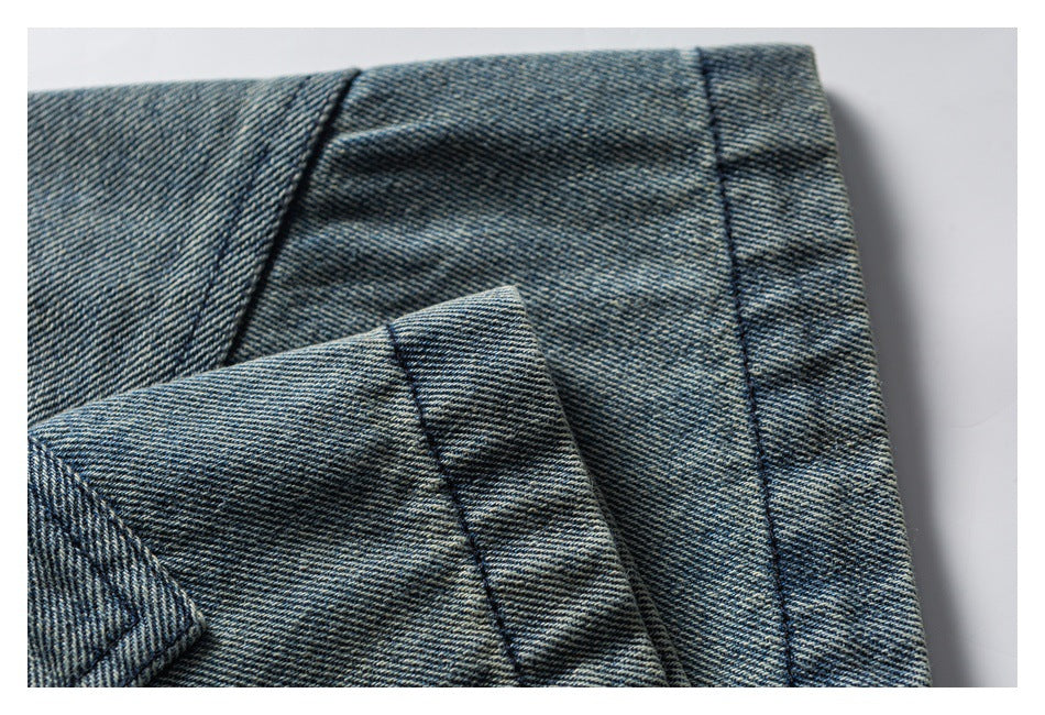 Close-up of folded blue denim edges showing stitched seams and a hem-like finish.