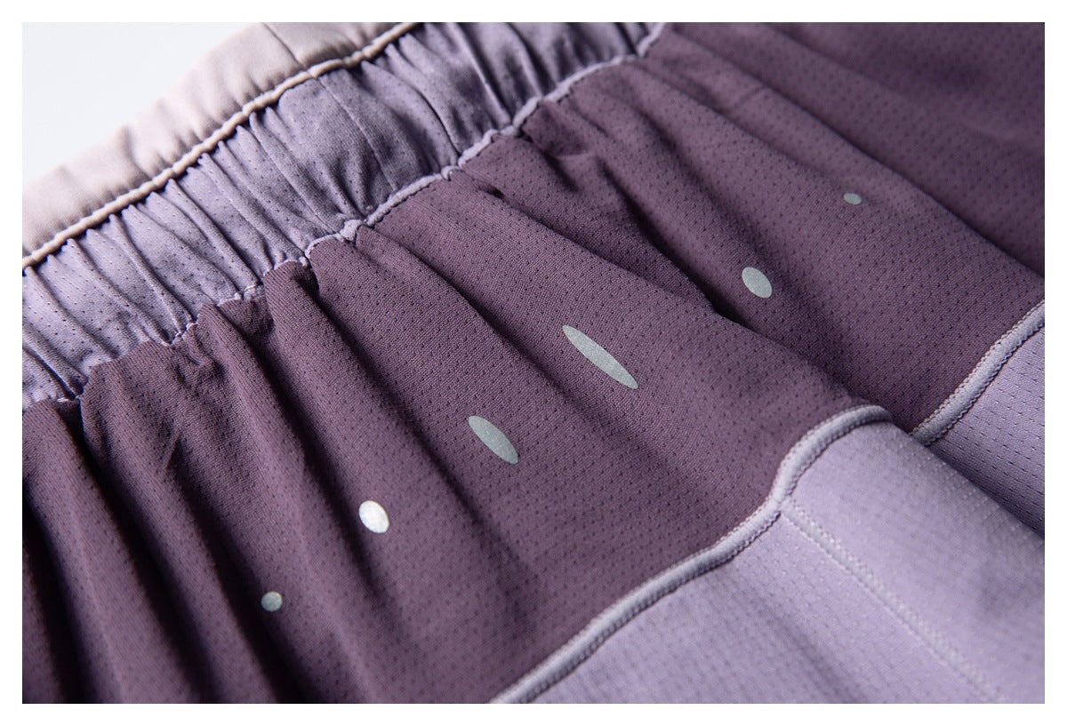 Close-up of gathered waistband and perforated purple fabric with pale oval and round details.