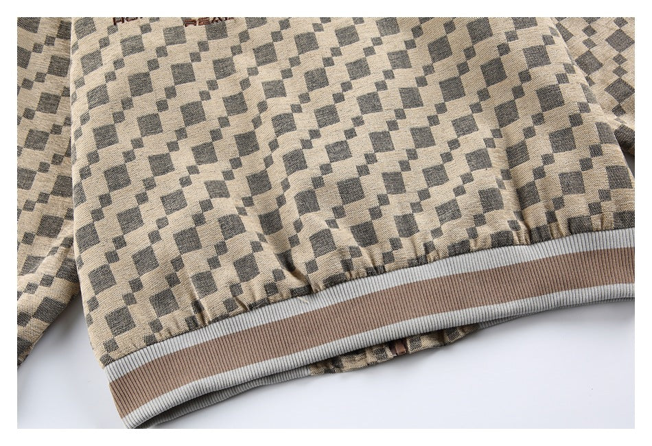 Close-up of beige and charcoal geometric-patterned fabric with a ribbed hem in taupe and light gray.