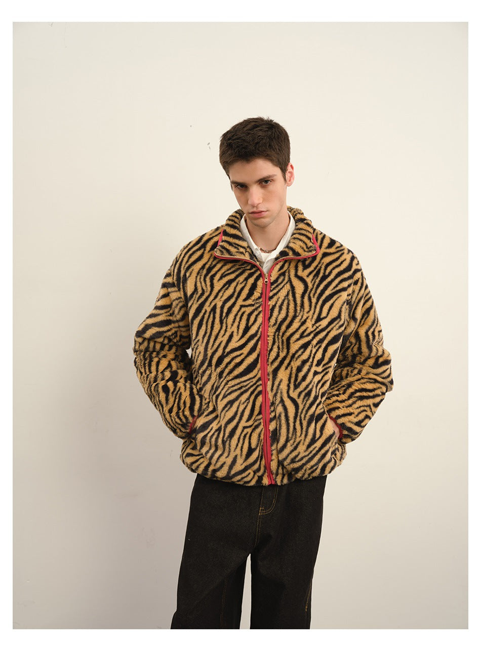 Model wearing a tan-and-black tiger-stripe zip fleece jacket with red trim, hands in the front pockets.