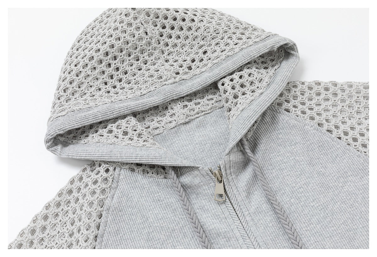 Close-up of the gray hoodie’s open-knit hood and sleeves, ribbed trim, and front zipper.