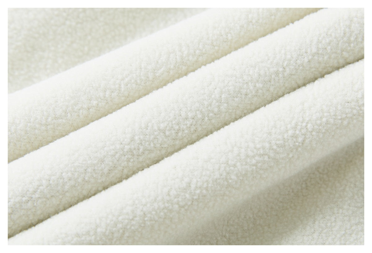 Close-up of ivory fabric in diagonal folds, showing a soft, raised textured surface.