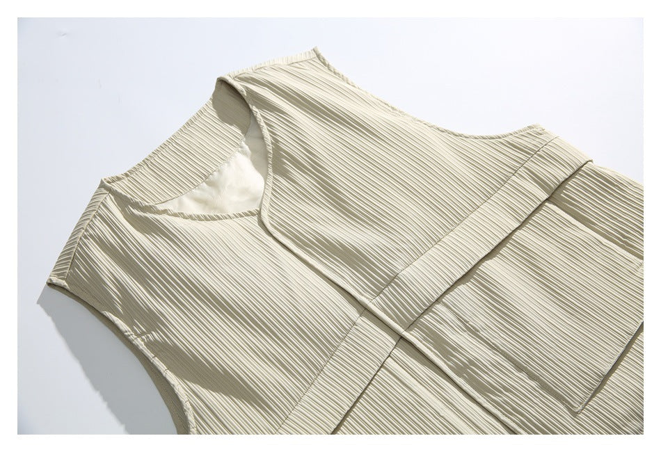 Close-up of the light beige ribbed vest, showing its V-neck, front panels, and pocket stitching.