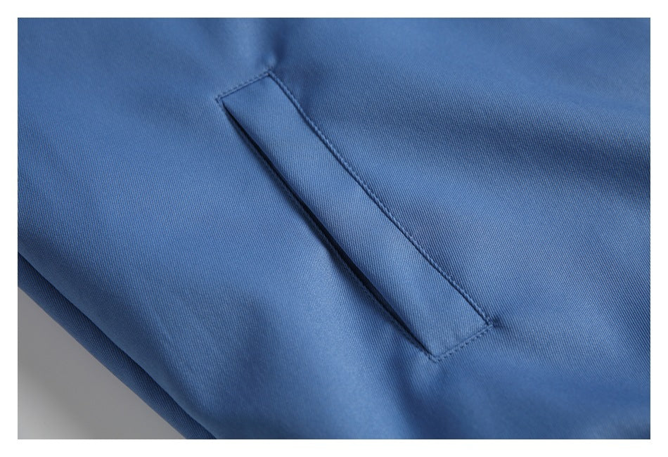 Close-up of a narrow welt pocket on blue fabric.
