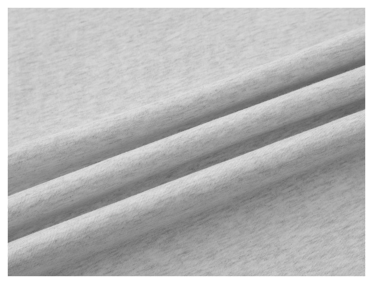 Close-up of the light gray shirt fabric draped into soft folds.