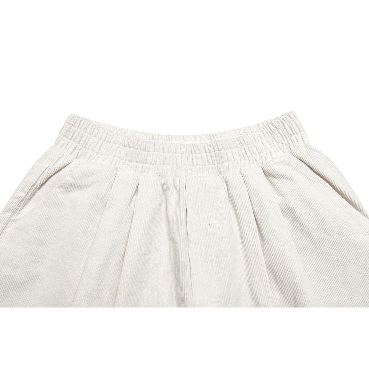 Close-up of off-white shorts showing the gathered elastic waistband and front pleats.
