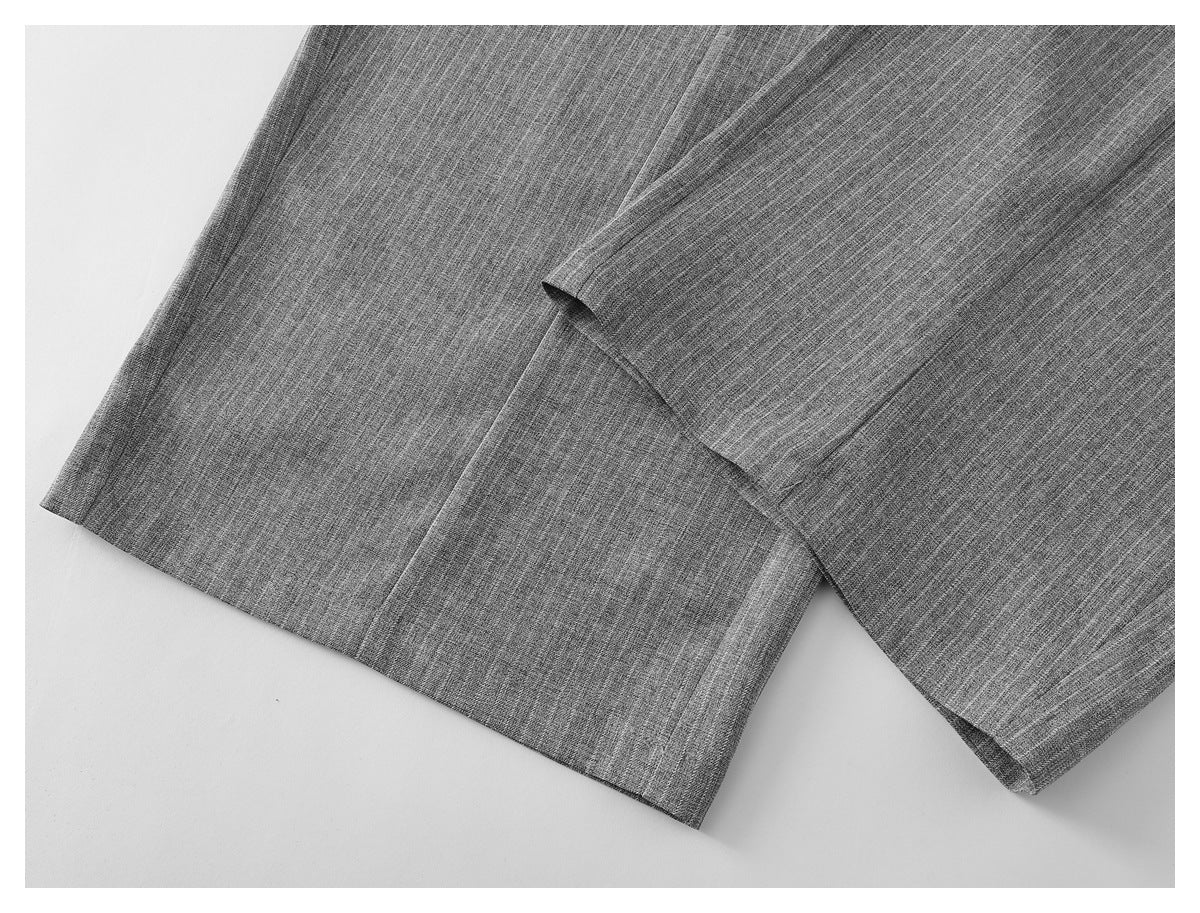 Close-up of the gray pinstriped trouser legs and straight hems.