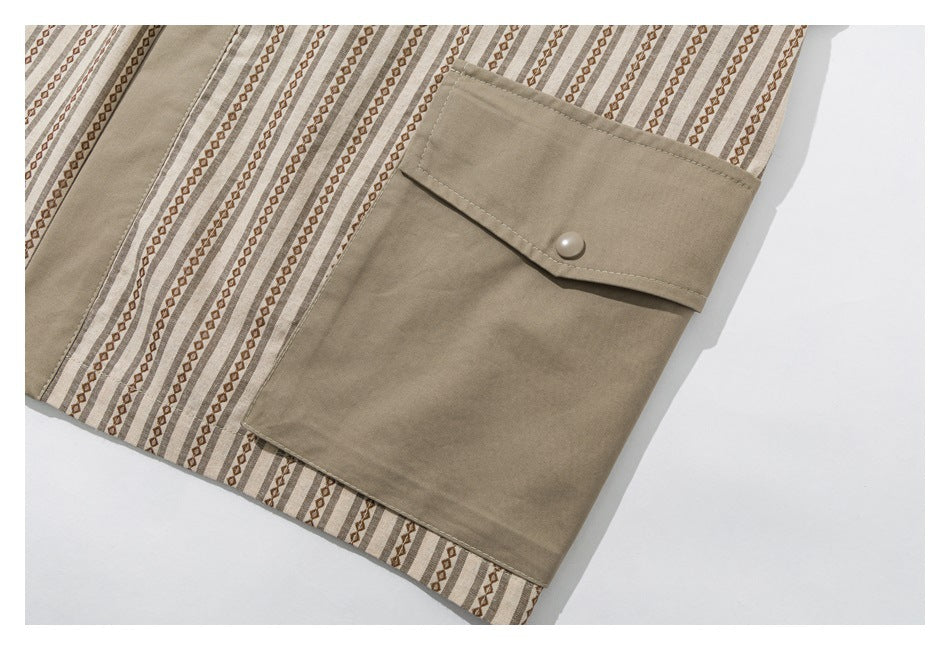 Close-up of a large taupe flap pocket with a round snap on a beige and brown patterned garment.