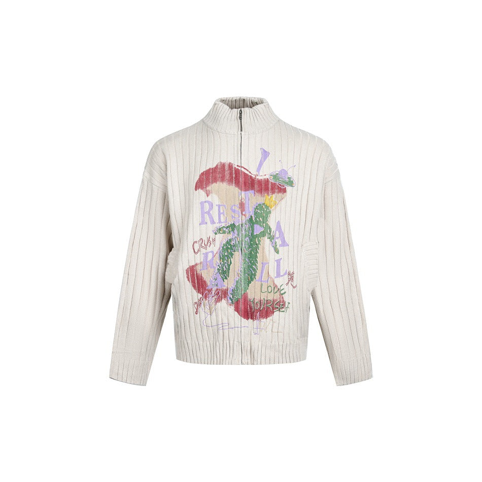 Beige wide-rib knit zip-front stand-collar sweater with a colorful apple core graphic on the front