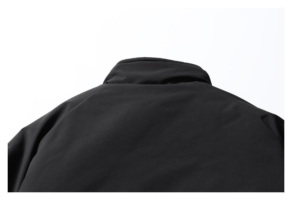 Close-up of the raised collar and upper back of a black jacket.