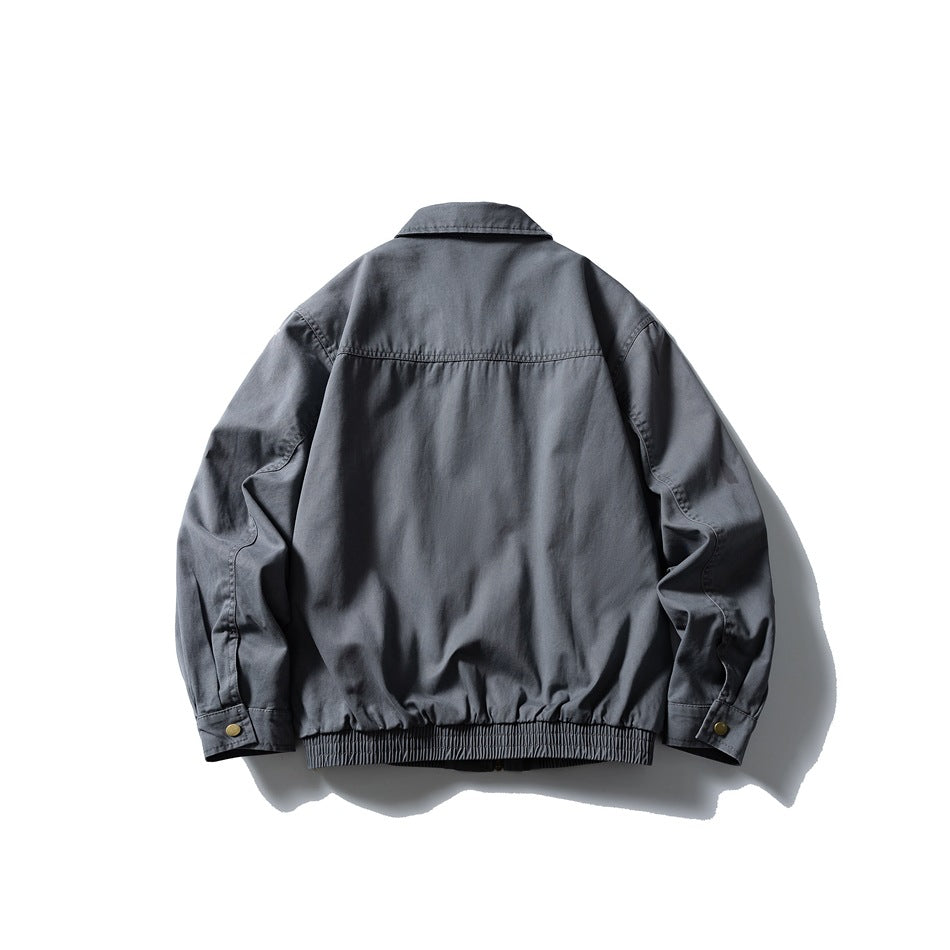 Back view of gray-blue collared jacket with yoke seam, snap cuffs and ribbed hem