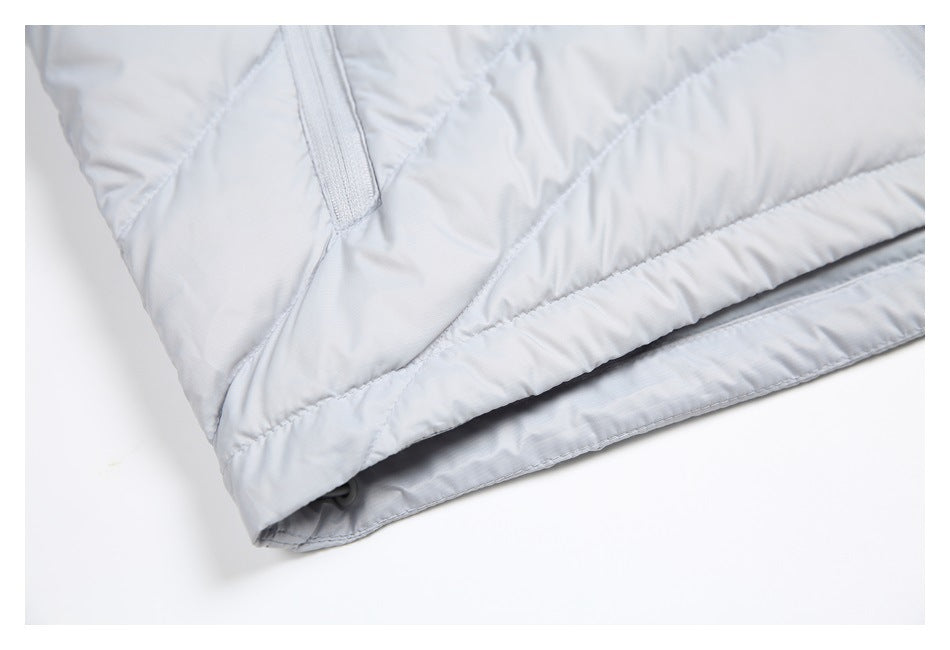 Close-up of the light gray quilted jacket's finished hem and lower edge.