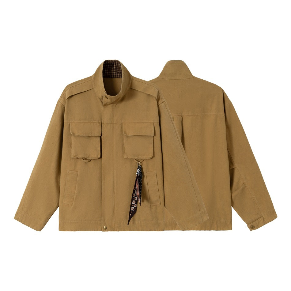 Tan utility jacket shown from the front and back, with a stand collar, flap pockets, and a patterned hanging accessory.