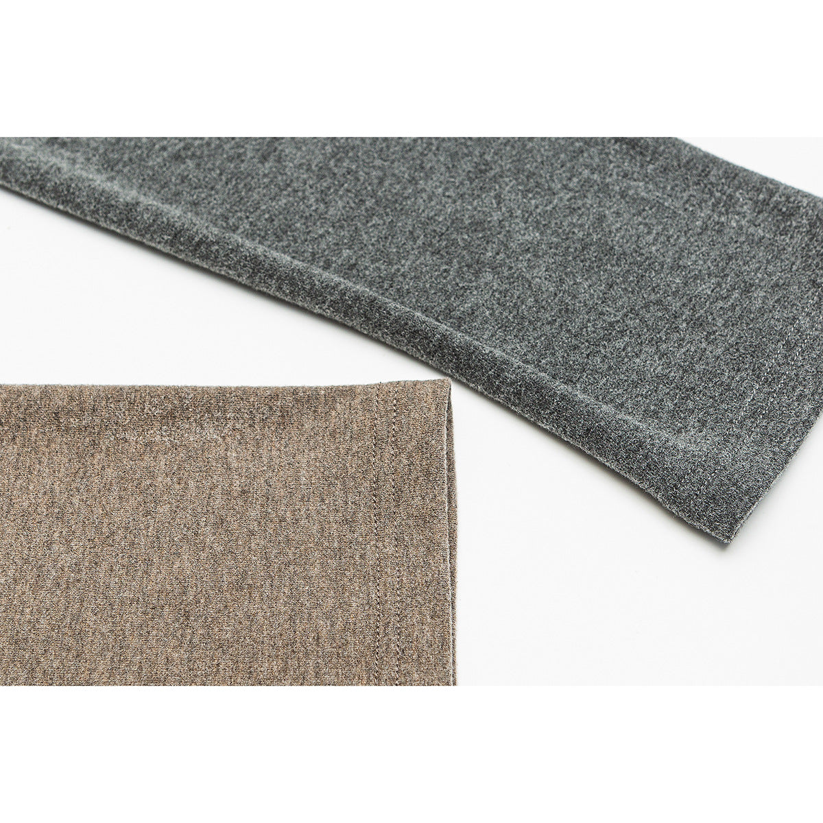 Close-up of taupe and charcoal heathered garment sections with finished edges on a white background.