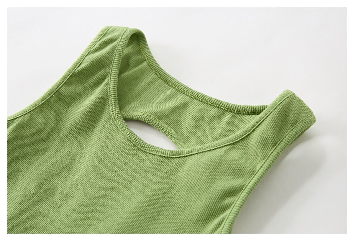 Close-up of a light green ribbed sleeveless top with bound edges and an oval cutout near the neckline.