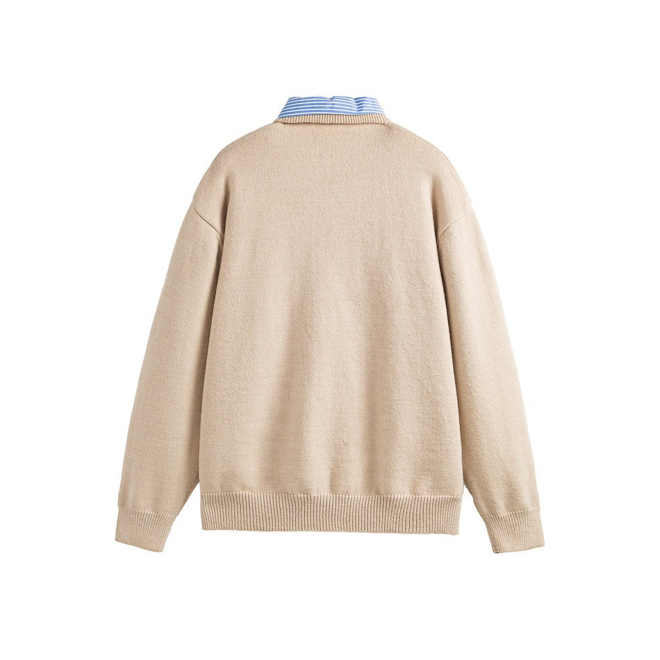 Back view of a beige long-sleeve sweater with ribbed cuffs and hem; a blue striped shirt collar shows above it.
