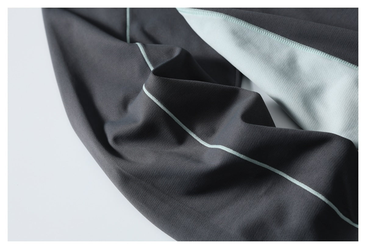 Charcoal garment fabric with pale mint lining and contrasting seam detail.