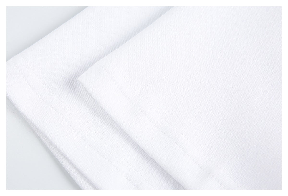 Close-up of folded white garment fabric with stitched edges.