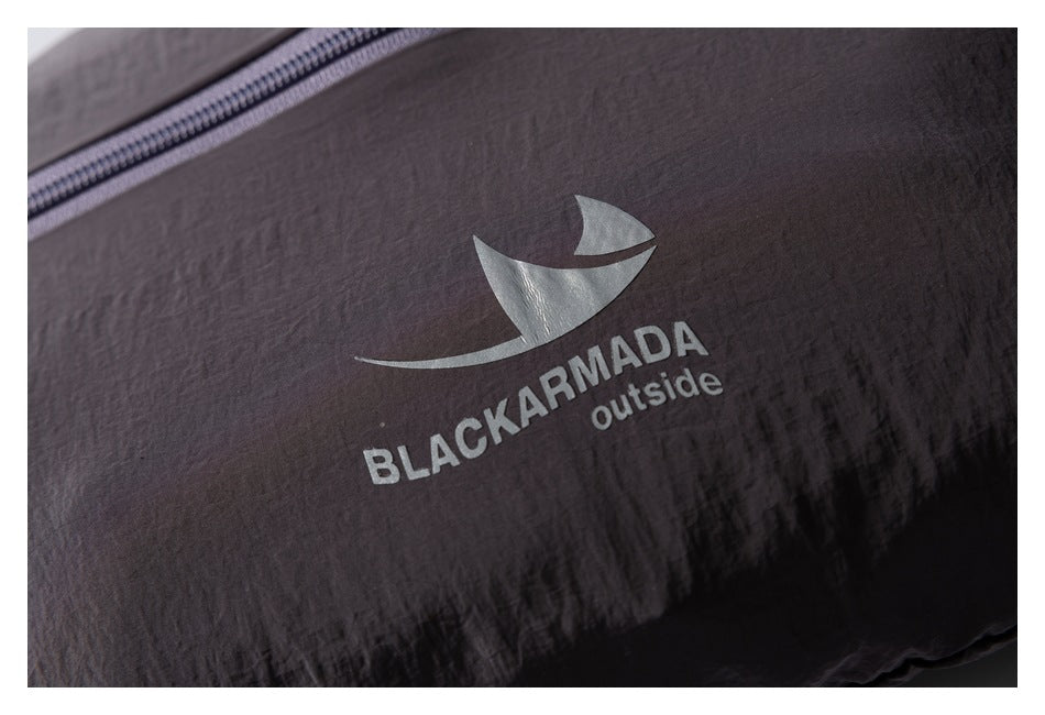 Close-up of a dark jacket showing a sail-like emblem and BLACKARMADA outside print.