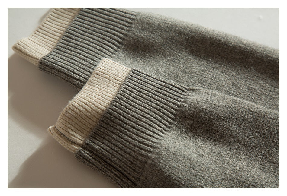 Close-up of two taupe-gray knit sleeve cuffs with contrasting beige ribbed ends.