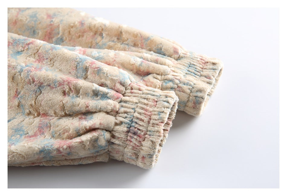 Close-up of the jacket's gathered cuffs in cream fabric with pink and blue patterning.