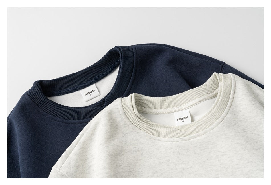 Close view of navy and light heather gray sweatshirts overlapping, showing their crew necklines and inside labels.