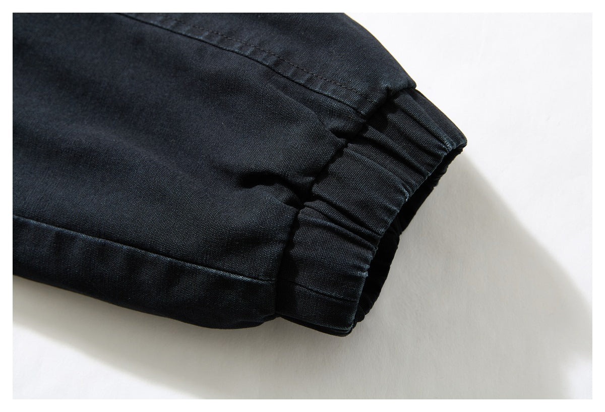 Close-up of a black garment's gathered cuff with visible stitching.