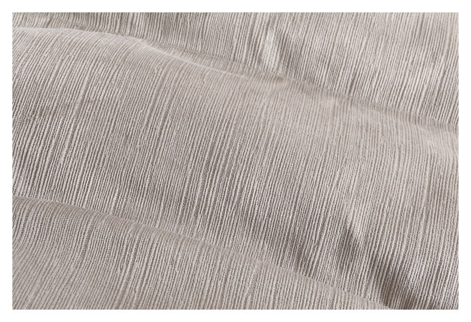 Close-up showing the fine ribbed texture and stitched seam of taupe-gray garment fabric.