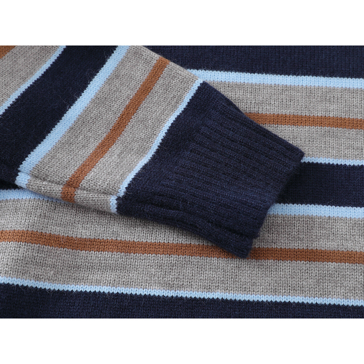 Close-up of a navy ribbed sweater cuff against gray knit with navy, light blue, and rust stripes.