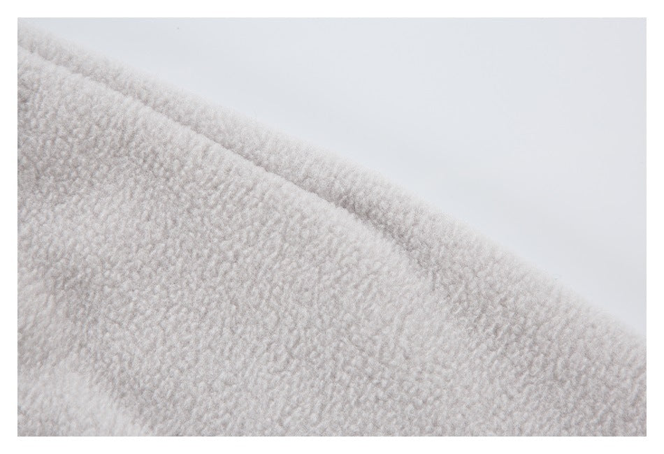 Close-up of the light gray jacket's soft, textured surface.