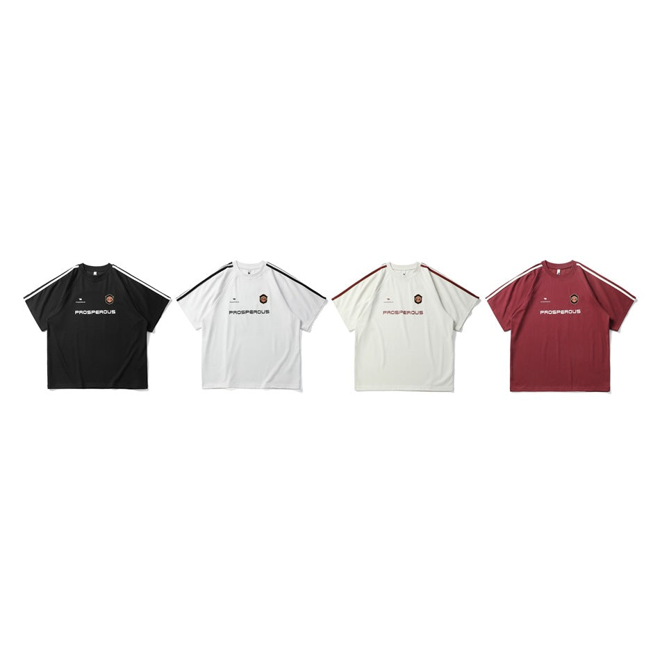 Four short-sleeve shirts shown from the front in black, white, cream and burgundy, with shoulder stripes and chest graphics.