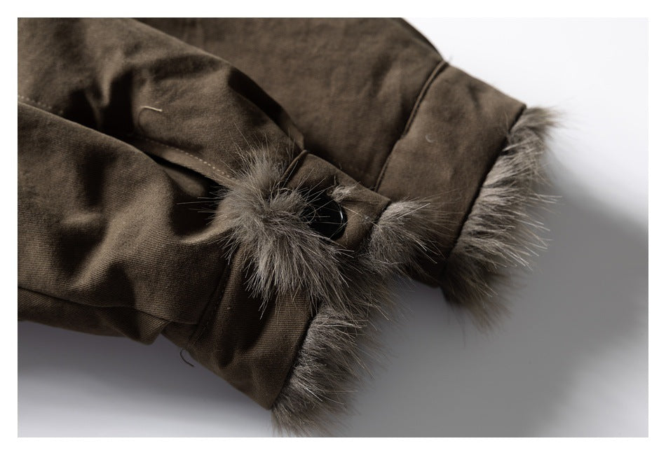 Close-up of a brown garment cuff with gray fur trim and a black button.