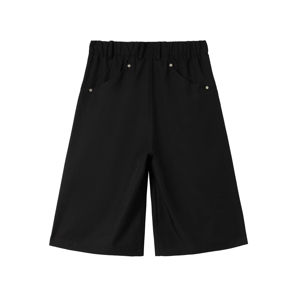 Black wide-leg shorts back view with elastic waistband and riveted back pockets, flat lay