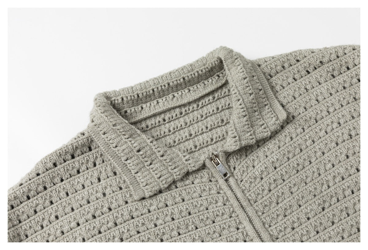 Close-up of the light gray cardigan's collar and metal zipper.