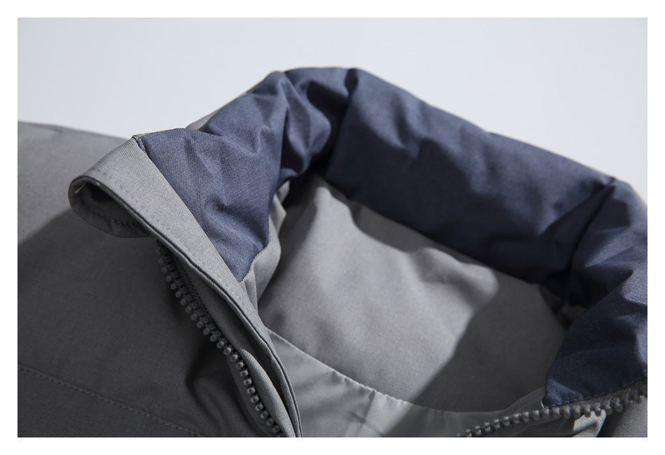 Close-up of the open gray jacket collar with dark blue inner fabric and front zipper.