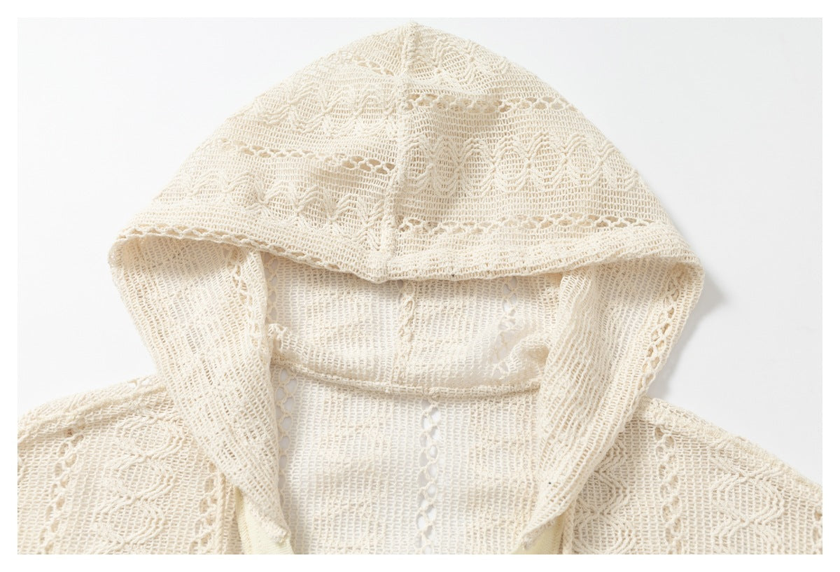 Close-up of the cream open-knit pullover’s patterned hood and textured crochet stitching.