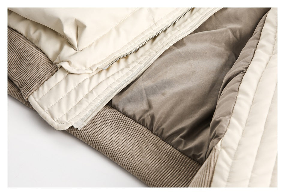 Close-up of the open cream jacket showing its taupe lining, zipper, and ribbed hem.