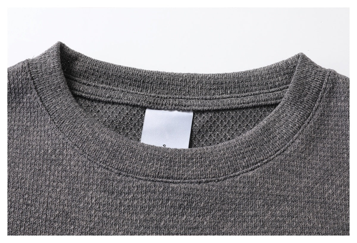 Close-up of the gray top's crew neckline, stitching, and inner size tag marked S.